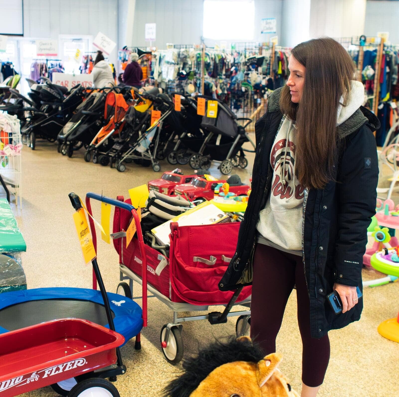 Mom shopping with full wagon.