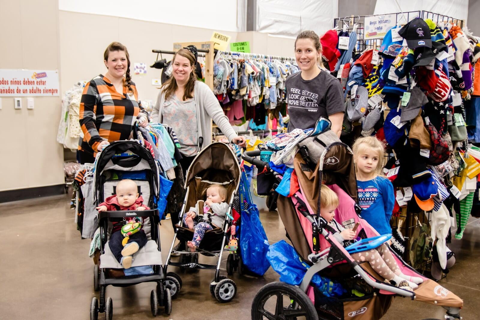 A group of shoppers wearing masks for safety reasons gathers together at the sale to shop.